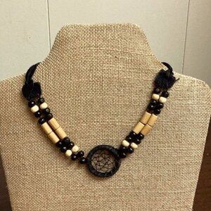 Black leather dreamcatcher choker with wooden beads. Leather straps tie SKU 056